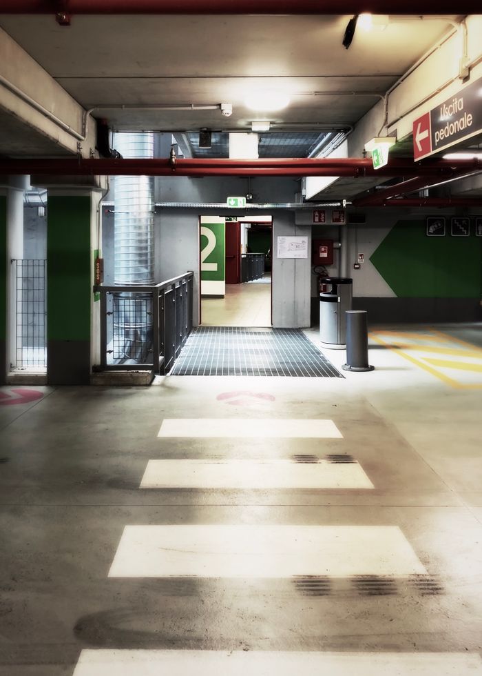 Contemporary indoor parking area with clear paths and signage.